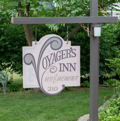 The wooden Voyager's Inn sign hangs with pride in the front lawn